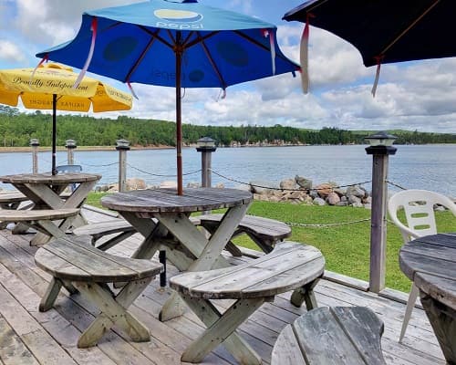 Picnic tables and umbrellas on the back deck overlooking the bay