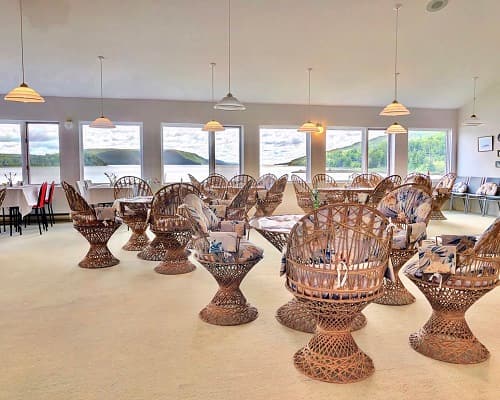 The upstairs event room set with tables and wicker chairs