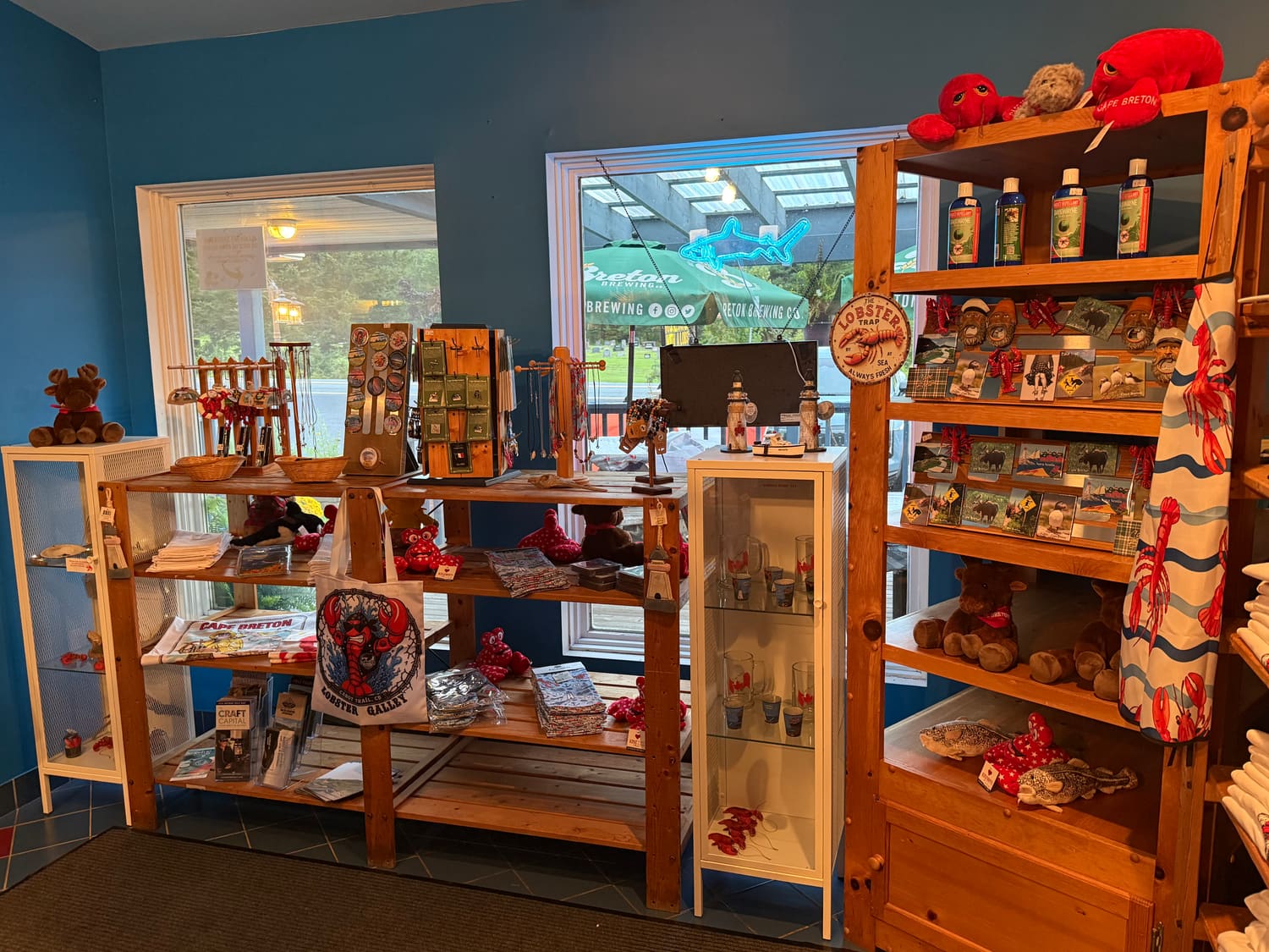 Gift shop shelves of plush lobsters, magnets, glassware and tote bags