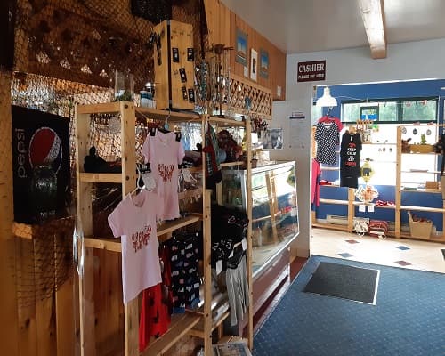 Inside the gift shop, with shelves of shirts and souvenirs