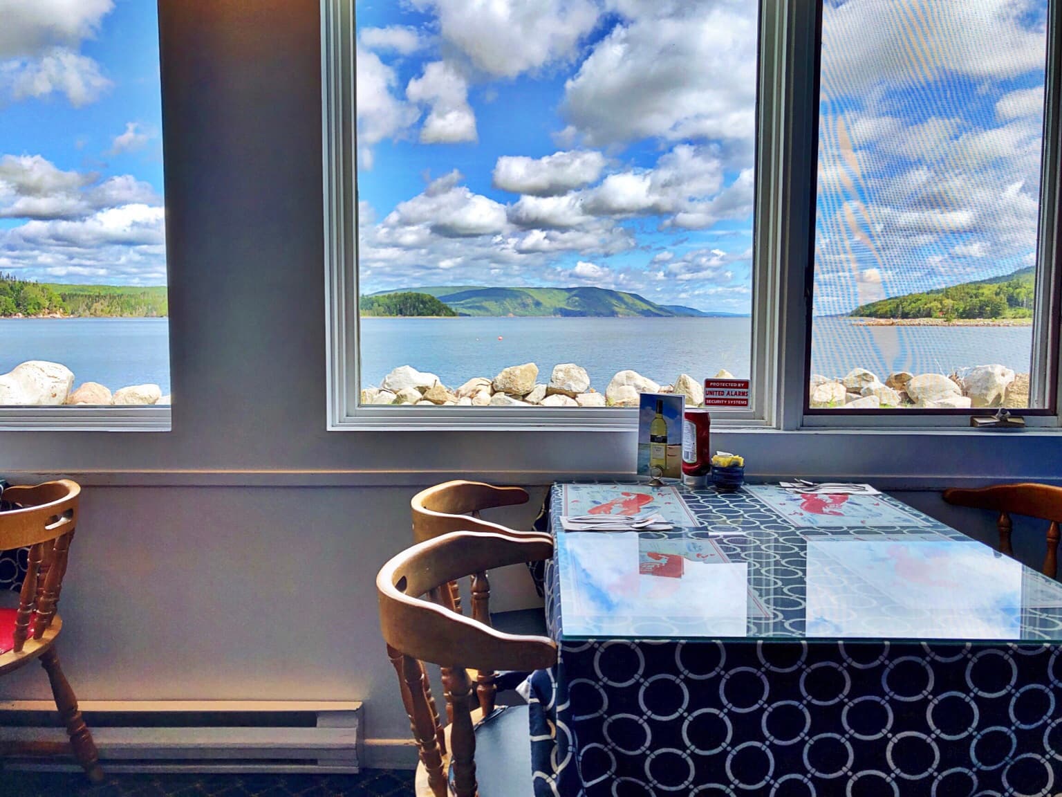 A window table set for dinner looking out over St. Ann's Bay